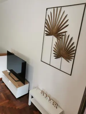 a living room with a tv and a mirror at Casa Antigone 99 in Mondello