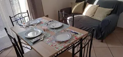 a table with plates and silverware on it with a couch at AI CANTIERI in Palermo