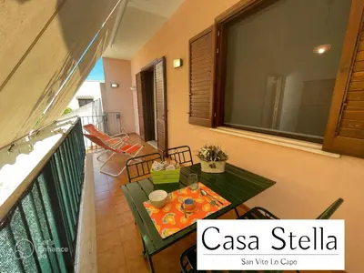 a balcony with a table and chairs on a balcony at Casa Stella San Vito Lo Capo in San Vito lo Capo