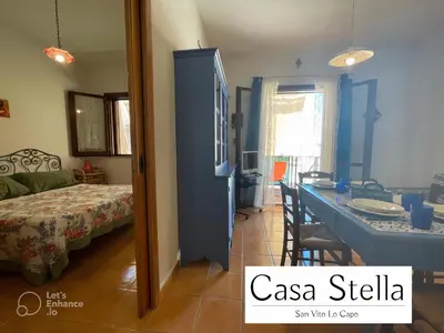 a room with a bed and a room with a table at Casa Stella San Vito Lo Capo in San Vito lo Capo