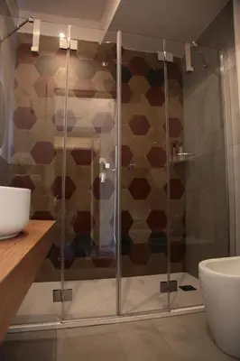 a shower with a glass door in a bathroom at Alle Absidi della Cattedrale in Palermo