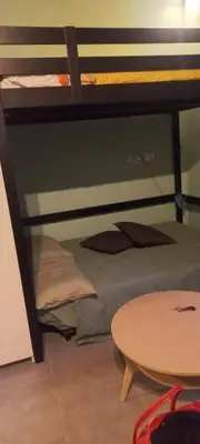 a room with two bunk beds and a table at casetta della cattedrale in Palermo
