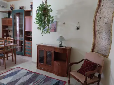 a living room with a chair and a mirror at ROOM VISTAMARE PALERMO in Palermo