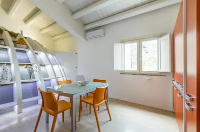 a dining room with a table and chairs at GuestHost - Palermo Modern Apartment with Swimming Pool in Palermo