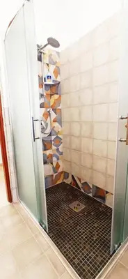 a shower with a glass door in a bathroom at Le Cummari in Castellammare del Golfo