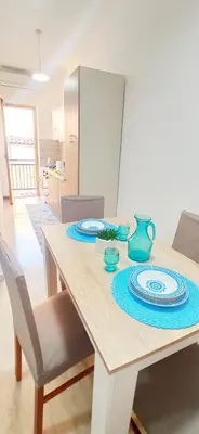 a dining room table with a blue plate on it at Le Cummari in Castellammare del Golfo