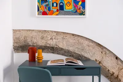 a blue desk with a book and a book at Tomasi Apartment Palermo in Palermo
