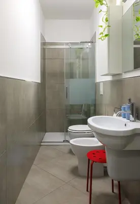 a bathroom with two sinks and a toilet and a shower at Tomasi Apartment Palermo in Palermo