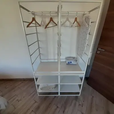 a white closet with clear shelves and hangers at Enzo'S Suite in Palermo