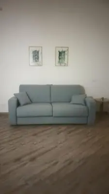 a blue couch sitting in a living room at Enzo'S Suite in Palermo