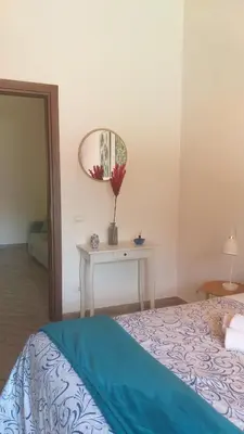 a bedroom with a bed and a table with a mirror at Enzo'S Suite in Palermo