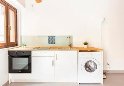 a kitchen with a sink and a washing machine at Vicolo del Capo in Palermo