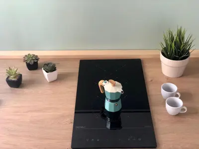 a figurine of a coffee maker on a table with plants at Vicolo del Capo in Palermo