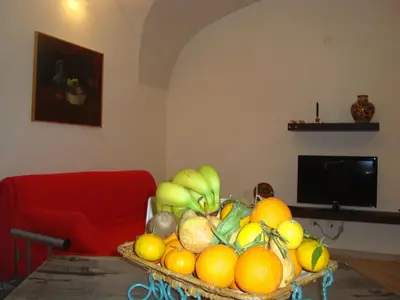 a living room with a flat screen tv on a wall at Daysin Apartment in Palermo