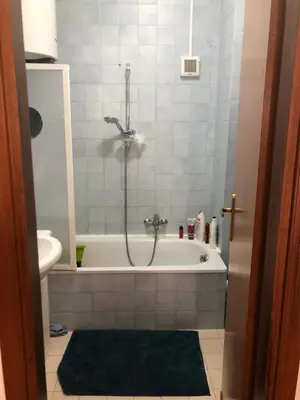 a bathroom with a tub with a shower and a toilet at Petrocelli 364 in Palermo