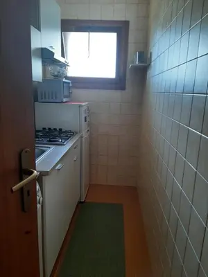 a small kitchen with a stove and a window at Petrocelli 364 in Palermo