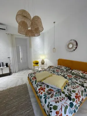 a bedroom with a large bed with a colorful blanket at Ischia suite in Termini Imerese