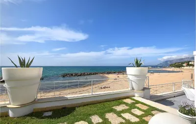 a balcony with two large white pots on a beach at 3 Bedroom Gorgeous Home In Trappeto in Trappeto