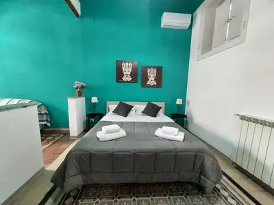 a bedroom with a large bed with two towels on it at La Casa del Moro - All' Operà in Palermo