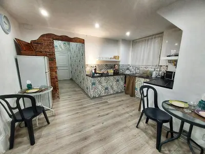 a kitchen with tables and chairs in a room at La Casa del Moro - All' Operà in Palermo
