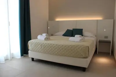 a bedroom with a bed with two towels on it at Coral Sand bed and breakfast in San Vito lo Capo