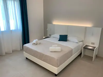 a bedroom with a bed with two towels on it at Coral Sand bed and breakfast in San Vito lo Capo