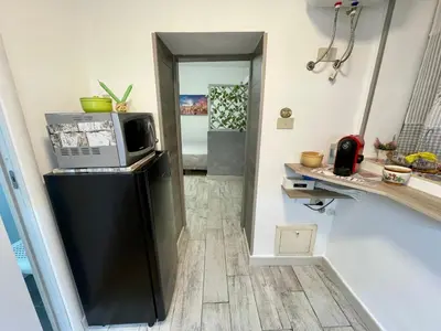 a kitchen with a microwave on top of a refrigerator at Casa Diema in Palermo