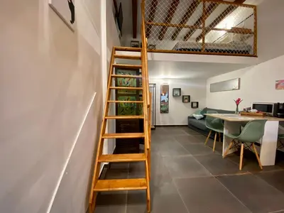 a wooden ladder in a living room with a table at Casa Labi in Termini Imerese