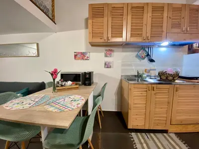 a kitchen with a wooden table and chairs in a kitchen at Casa Labi in Termini Imerese