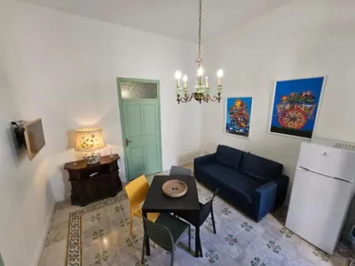 a living room with a blue couch and a table at Lu Màri case vacanze in Balestrate