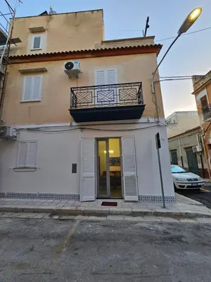 a white building with a balcony on top of it at Lu Màri case vacanze in Balestrate