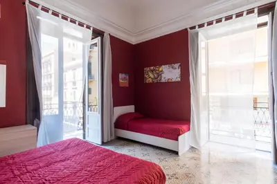 a living room with a couch and a mirror at CORNER ROME appartamento in Palermo