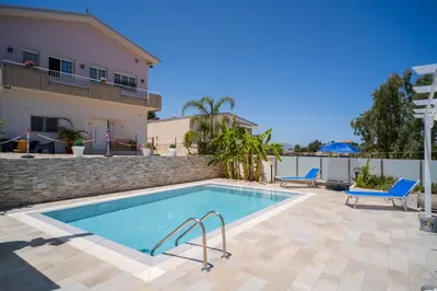 a swimming pool in front of a house at holiday inn endless summer in Alcamo