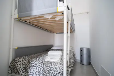 a bedroom with a bunk bed with a leopard print bedspread at holiday inn endless summer in Alcamo