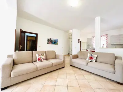 a living room with two couches in a room at Villa Genova in Carini