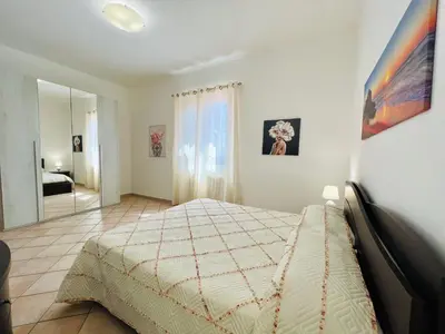 a bedroom with a bed and a mirror at Villa Genova in Carini
