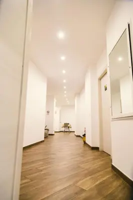 an empty room with white walls and wooden floors at Galka Rooms in Palermo