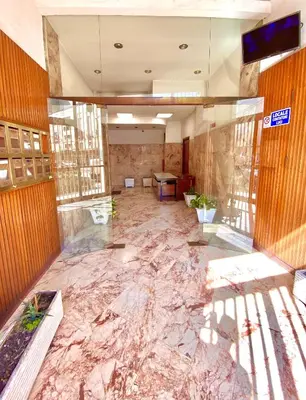 an empty lobby with a marble floor in a building at Galka Rooms in Palermo