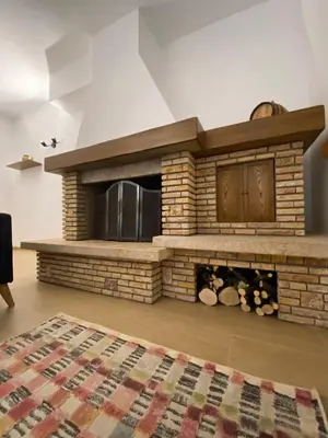 a living room with a brick fireplace at Artemide 15 New Apartment near Mondello in Palermo