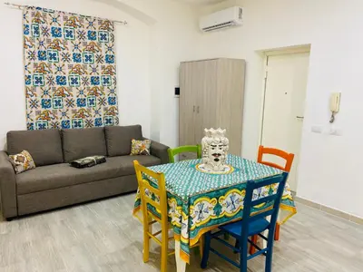 a living room with a table and a couch at A un passo dalla cattedrale in Palermo