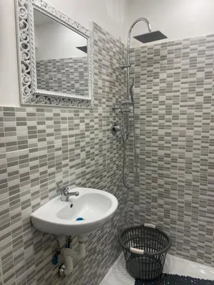 a bathroom with a sink and a shower with a mirror at A un passo dalla cattedrale in Palermo