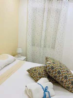 a bedroom with a bed with towels and a window at A un passo dalla cattedrale in Palermo