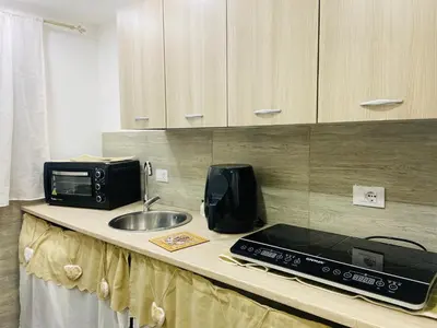 a kitchen counter with a microwave and a sink at A un passo dalla cattedrale in Palermo