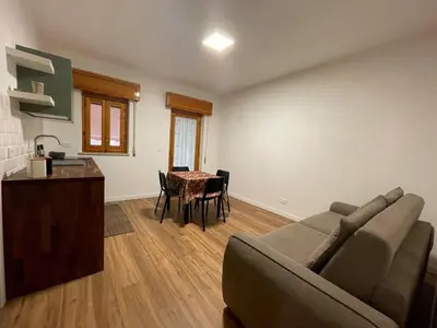 a living room with a couch and a table at TOURIST HOUSE Le casette di Sofì in Bagheria