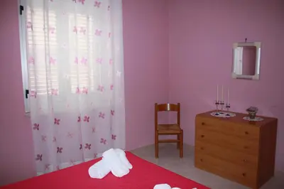 a bedroom with a bed and a dresser and a mirror at GB Case Vacanze Sicilia in Balestrate