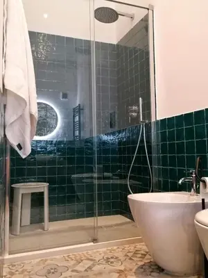 a bathroom with a shower and a toilet and a sink at I Canti Comfort Rooms in Palermo