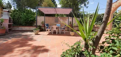 a patio with a table and chairs under a canopy at Villa Paola appartamento completo in Ciminna