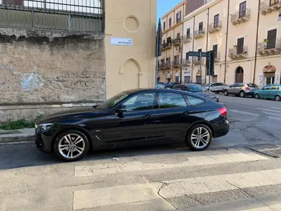 a black car parked on the side of a street at Due Cani Apartment in Palermo