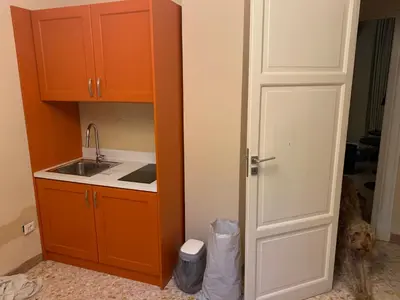 a kitchen with a sink and an open door at Due Cani Apartment in Palermo