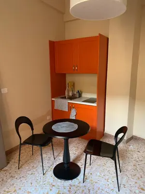 a small kitchen with a table and two chairs at Due Cani Apartment in Palermo